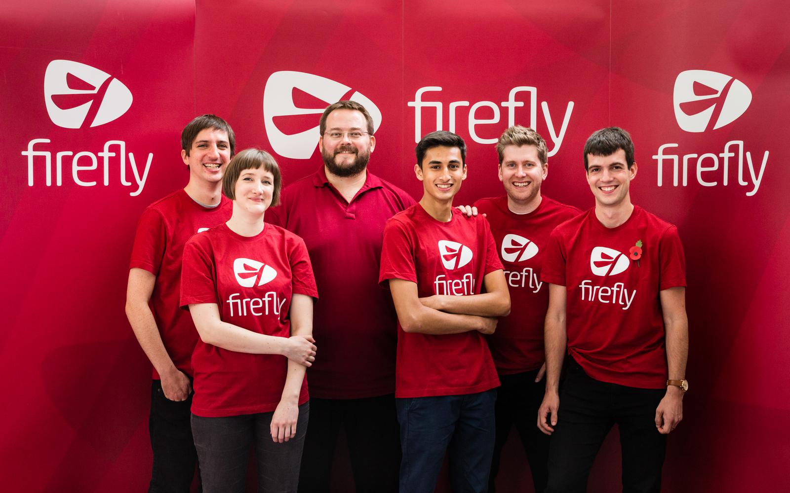 7 of us pose in red Firefly branded t-shirts.